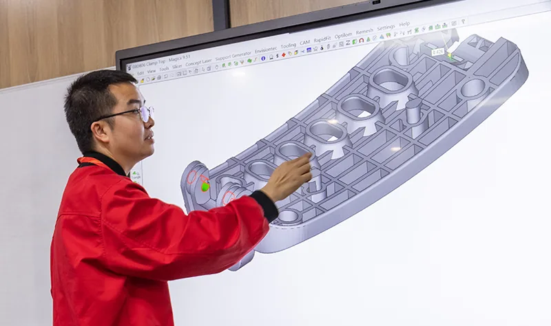 Engineering team reviewing overmolding quality and part design
