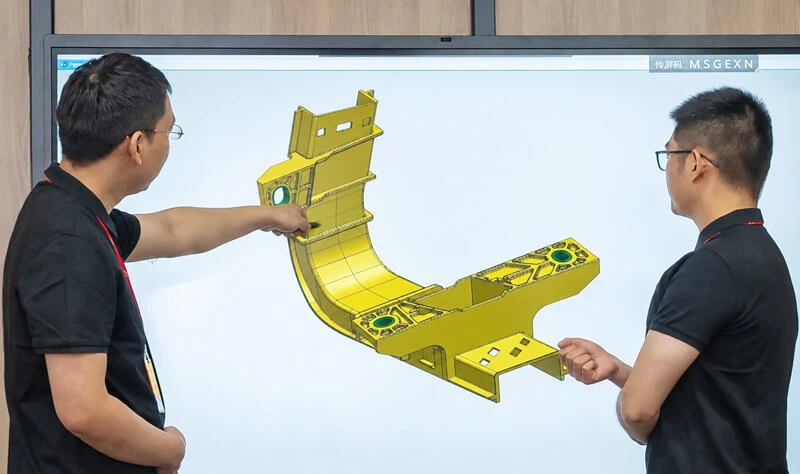 Engineering team reviewing insert molding quality and part design